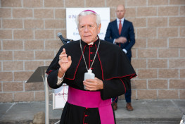 Bishop conducts a blessing with holy water