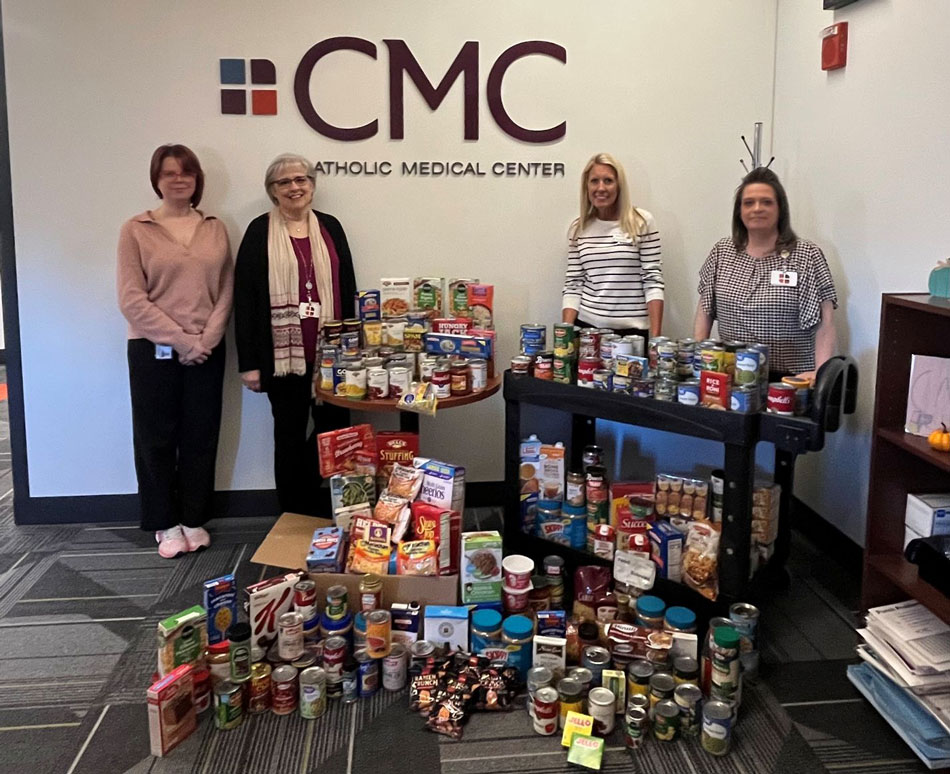 colleagues from CMC gathered around donated food items