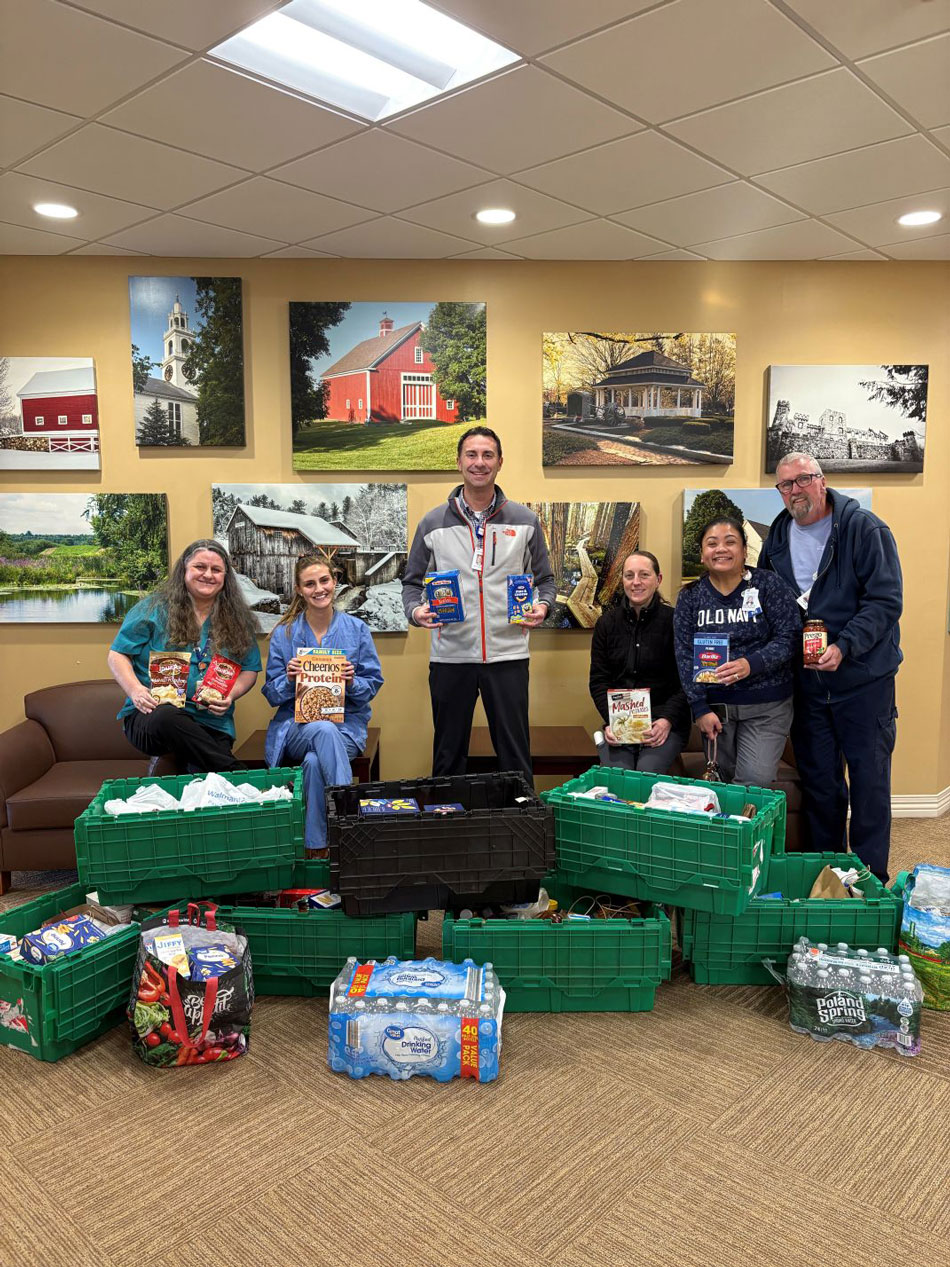 colleagues from Frisbie Memorial Hospital gathered around donated food items